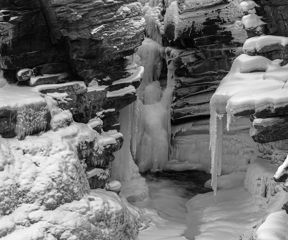 683 megapixels! A very high resolution, large-format, black & white photo print of a winter landscape with a frozen waterfall, a canyon, snow-covered ground, and a beautiful mountain; landscape photograph created by Scott Dimond in Jasper National Park, Alberta, Canada.
