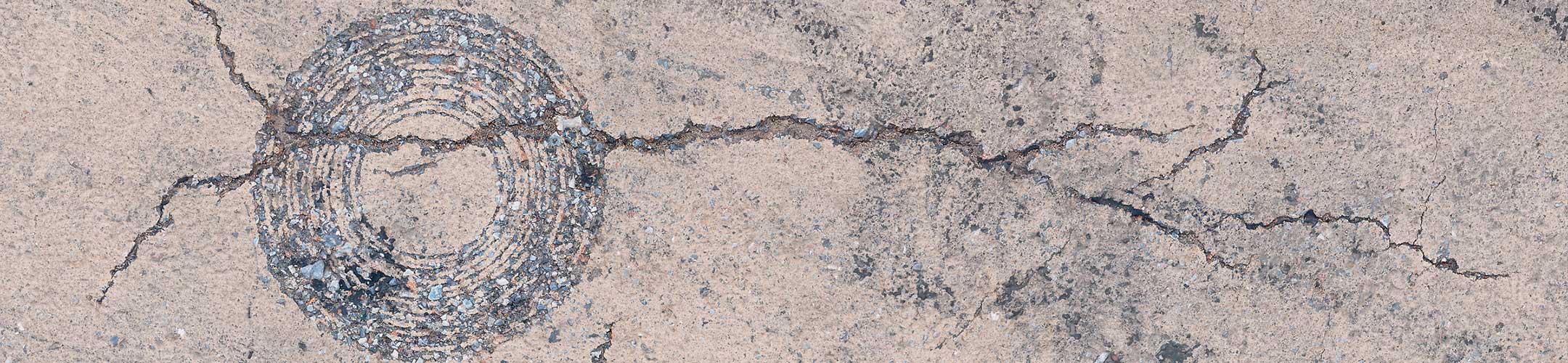 Photo of artistic cracks on the sidewalk.