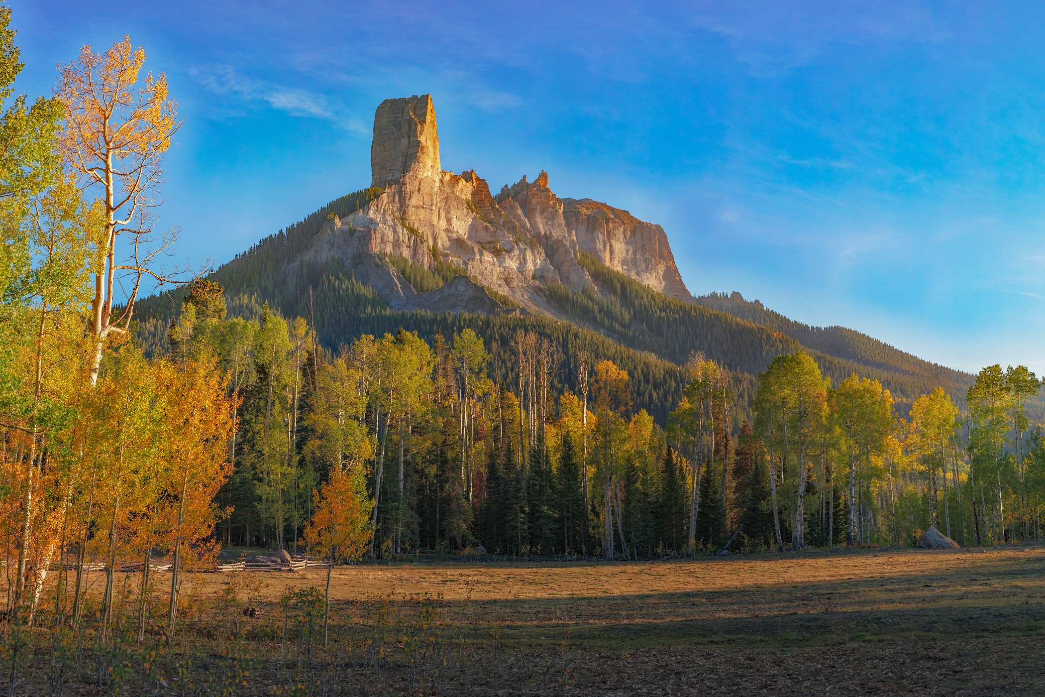1,015 megapixels! A very high resolution, wall art photo of a mountain at sunset with autumn trees in the foreground; landscape photograph created by John Freeman in Deb's Meadow, Cimarron Ridge, San Juan Mountains, Colorado.