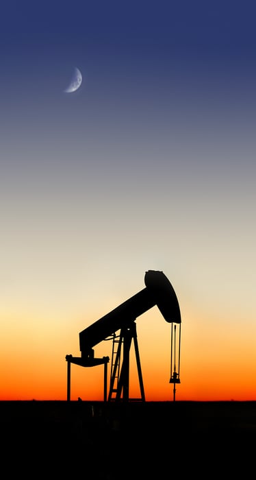 177 megapixels! A very high resolution, fine art photo print of the silhouette of an oil pumpjack at sunset with the moon in the sky; photograph created by Phil Crawshay.