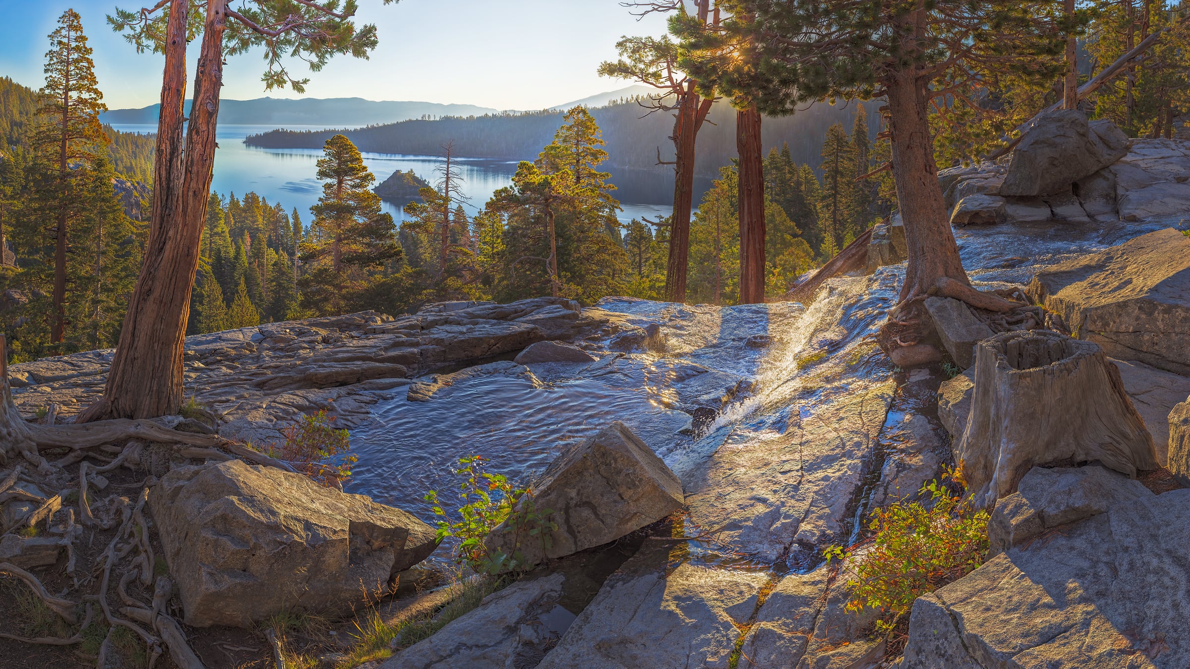 3,419 megapixels! A gigapixel stock photo of a nature scene with a stream running across rocks in a forest with a beautiful lake in the background; created by John Freeman at Eagle Falls, Lake Tahoe, California; available to be licensed and downloaded.