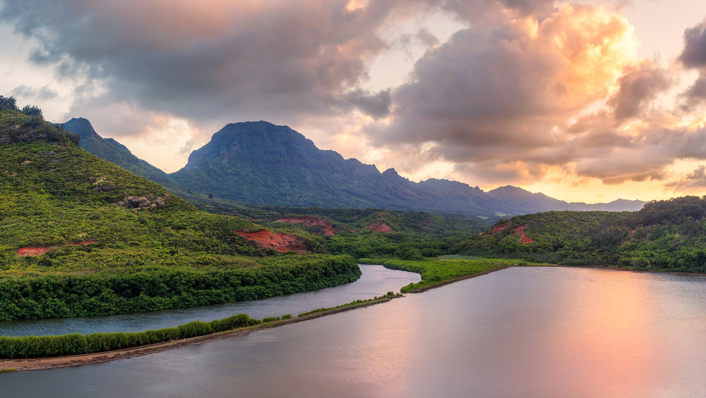 352 megapixels! A very high resolution, large-format VAST photo print of a landscape at sunset on Kauai island in Hawaii with the Alekoko Fishpond in the foreground, mountains in the background, and sunset-illuminated clouds in the sky; photograph created by Chris Blake at Menehune Fishpond on Kauai, Hawaii.