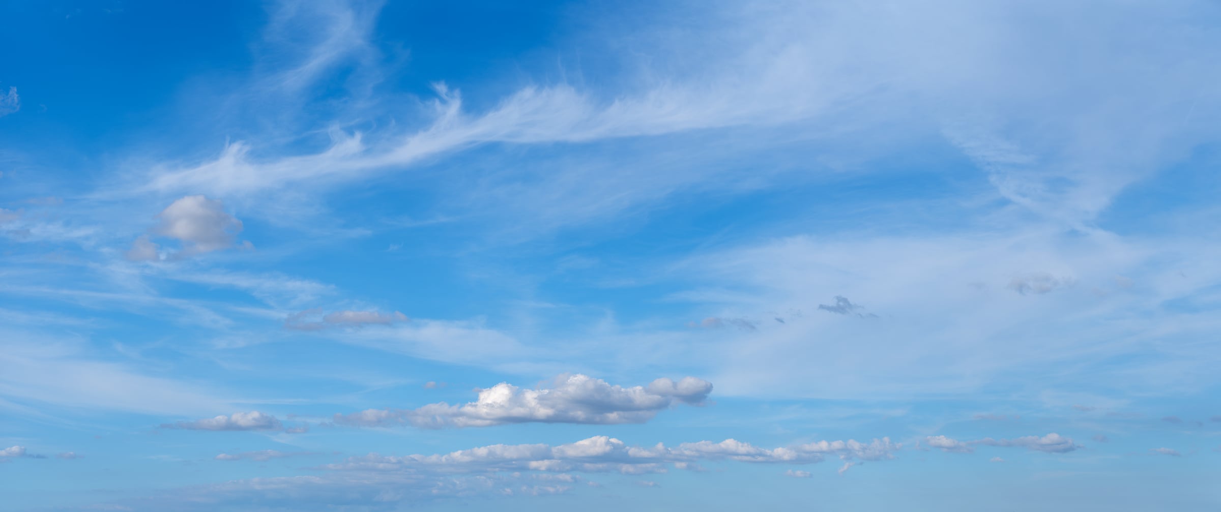 313 megapixels! A very high resolution, large-format VAST photo of a beautiful blue sky with wispy white clouds and a few puffy white clouds; stock photograph created by Assaf Frank and available to be licensed and downloaded.