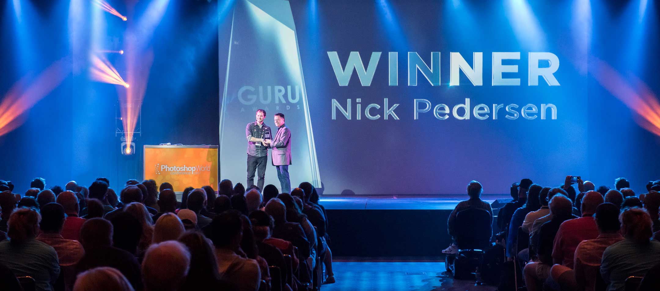 A picture of Nick Pedersen, a VAST artist, getting a prestigious award.